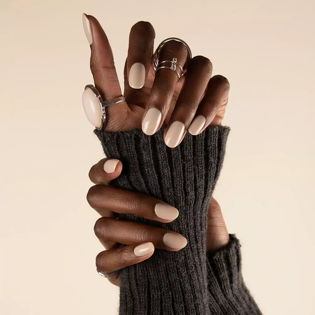 Hand with dark skin tone wearing Bio Sculpture Crescent Moon – subtle, vegan soft grey polish for inclusive, stylish manicures