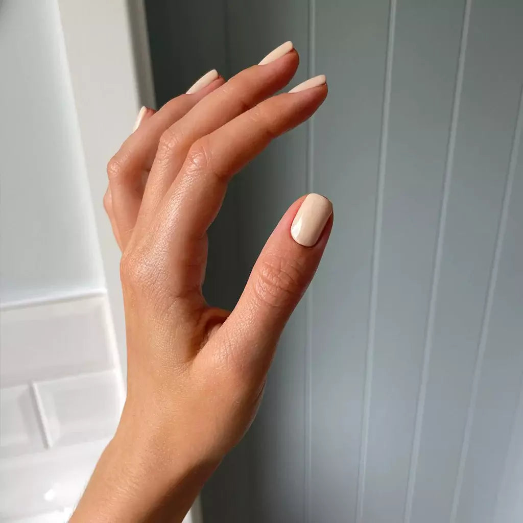 Hand with light skin tone wearing Bio Sculpture Crescent Moon – gentle, vegan soft grey polish for an elegant, understated manicure