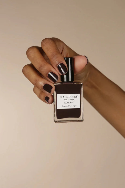 Hand with darker skin tone wearing Nailberry Noirberry – deep, vegan berry polish for sophisticated, inclusive manicures