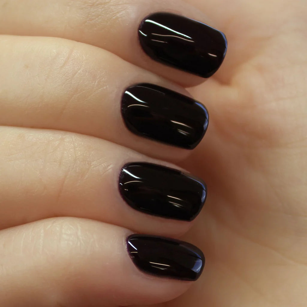 Hand with light skin tone wearing Bio Sculpture Gemini Nail Polish No. 255 Knights Armour – vegan, deep dark violet polish for a chic, elegant nail look