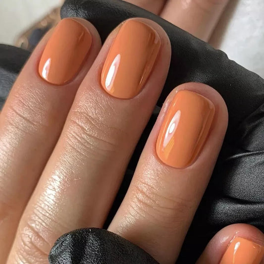Hand with light skin tone wearing Bio Sculpture Gemini Nail Polish No. 266 Clay Pathway – vegan, peachy yellow clay polish for a chic, natural manicure