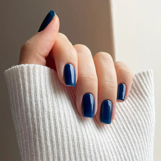 Hand with light skin tone wearing Bio Sculpture Gemini Nail Polish No. 268 Blue Mushroom – vegan, rich blue-grey polish for a chic, sophisticated manicure