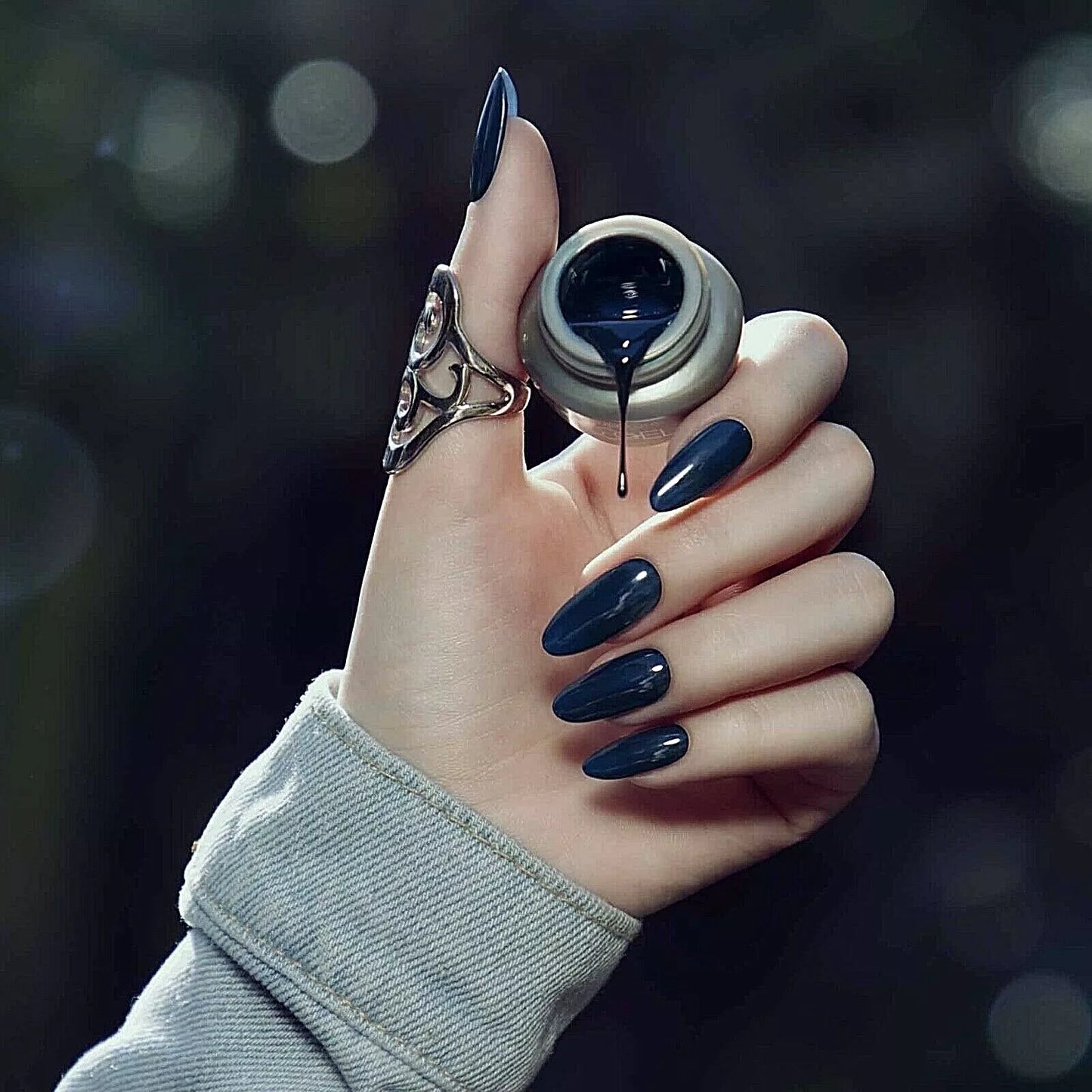 Hand with dark skin tone wearing Bio Sculpture Gemini Nail Polish No. 268 Blue Mushroom – bold, vegan blue-grey polish for inclusive, elegant manicures