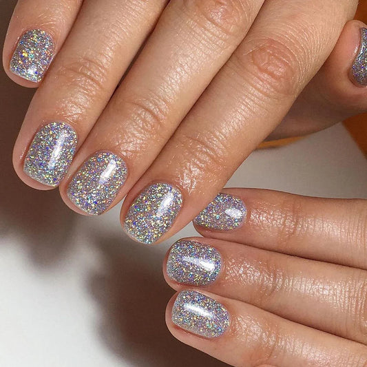 Close-up of Bio Sculpture Gemini Nail Polish No. 272 Popping Petals polish on light skin – non-toxic, multi-coloured glitter for a lively, statement nail look