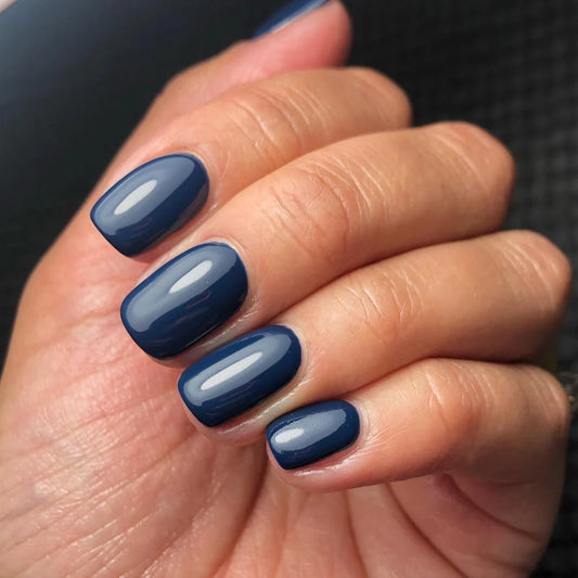Close-up of Bio Sculpture Gemini Nail Polish No. 277 Showboat polish on light skin – non-toxic, deep royal blue shade for a chic, sophisticated nail look
