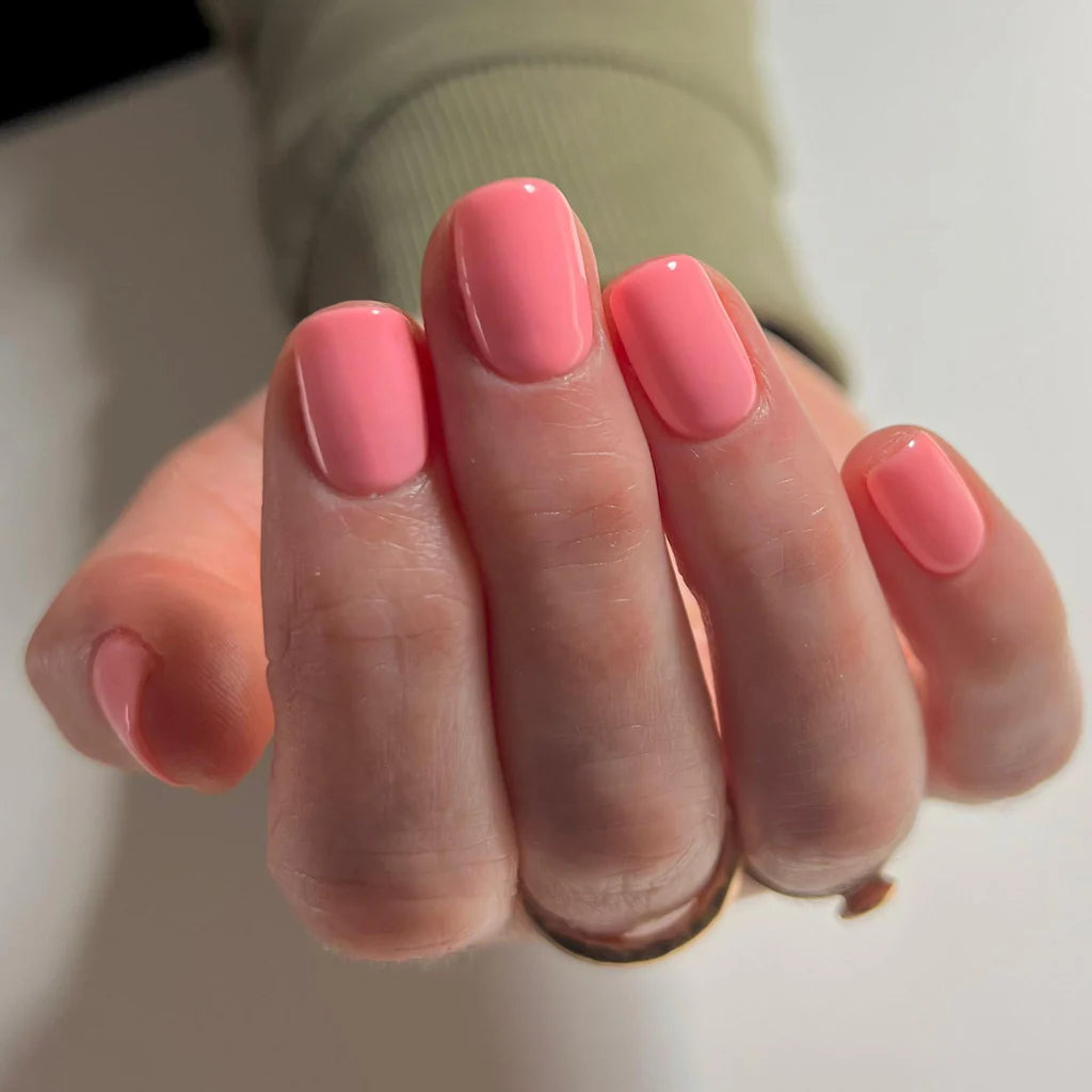 Bio Sculpture Gemini Nail Polish No. 299 Strawberry Gelato 14ml. Close-up of Strawberry Gelato polish on light skin – non-toxic, creamy pastel pink shade for a sweet, modern nail look