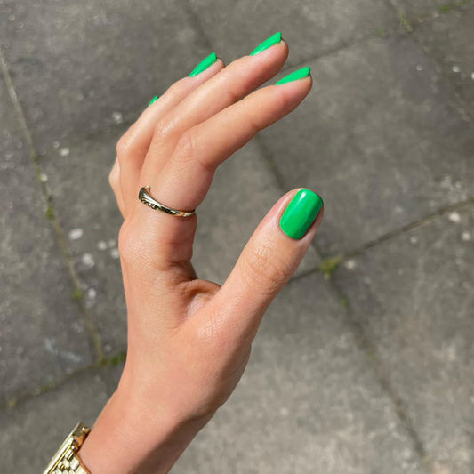 Hand with light skin tone wearing Bio Sculpture Verde – vivid, vegan green polish for a fresh, statement manicure