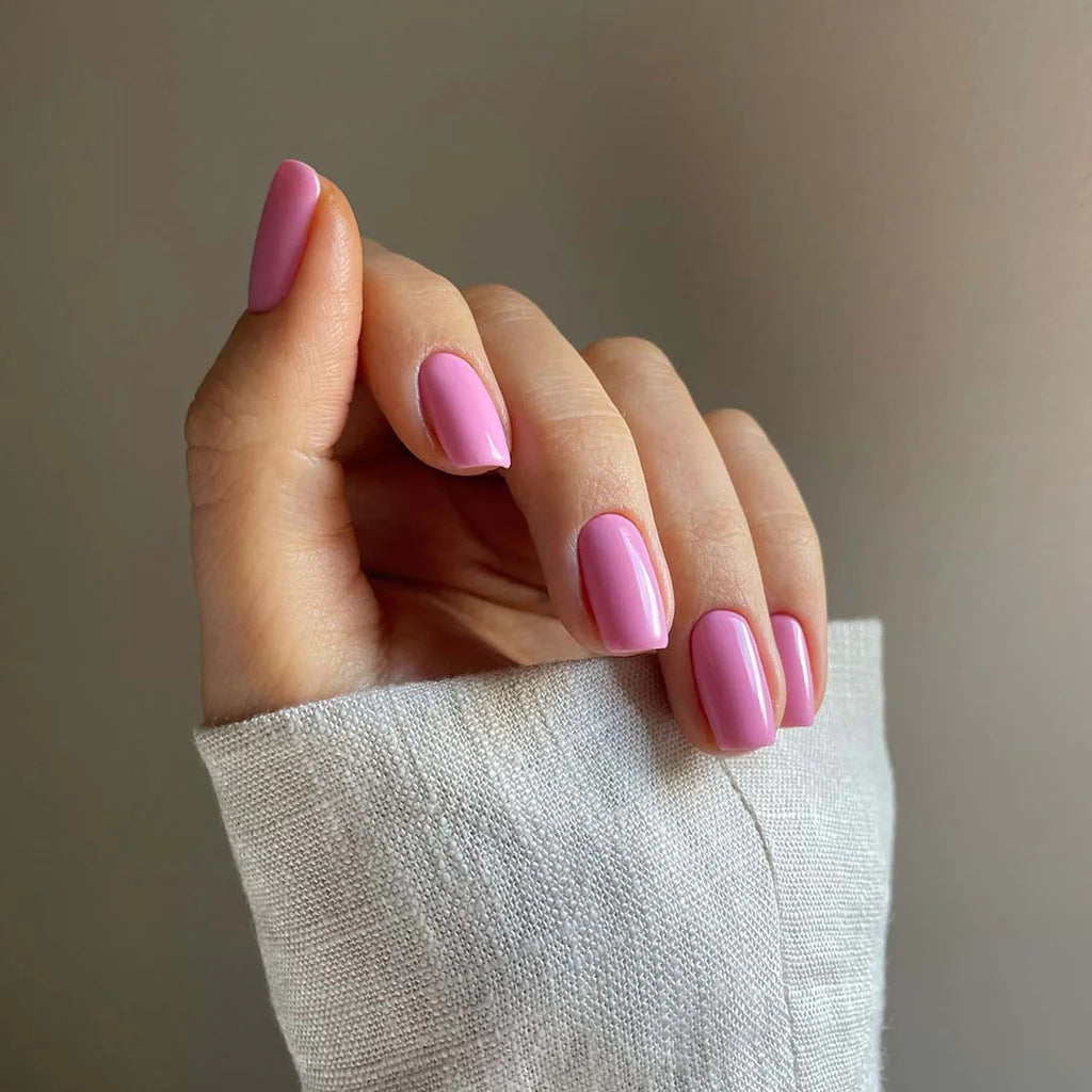 Hand with light skin tone wearing Bio Sculpture Flower in Flight – soft, vegan pastel blue polish for a chic, modern manicure