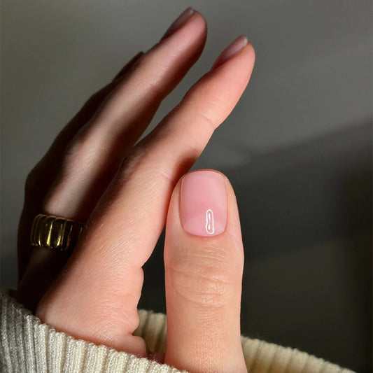 Hand with light skin tone wearing Bio Sculpture Sheer Admiration – delicate, vegan sheer pink polish for a fresh, understated manicure