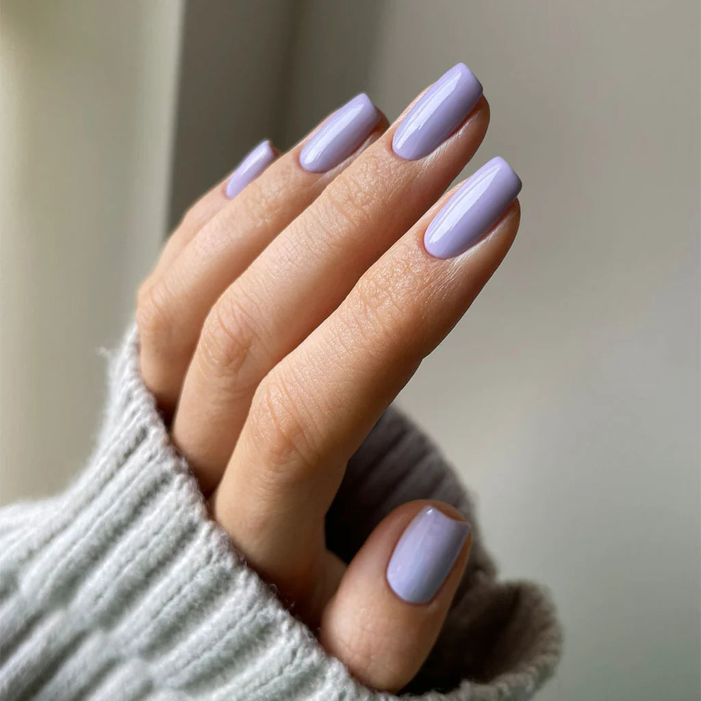 Fingers with light skin tone featuring Nailberry Peony Blush – gentle, cruelty-free peony pink polish for a chic, understated nail style