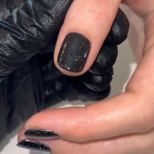 Close-up of Starry Night polish on light skin – non-toxic, deep blue shade with delicate shimmer for a radiant, modern nail look