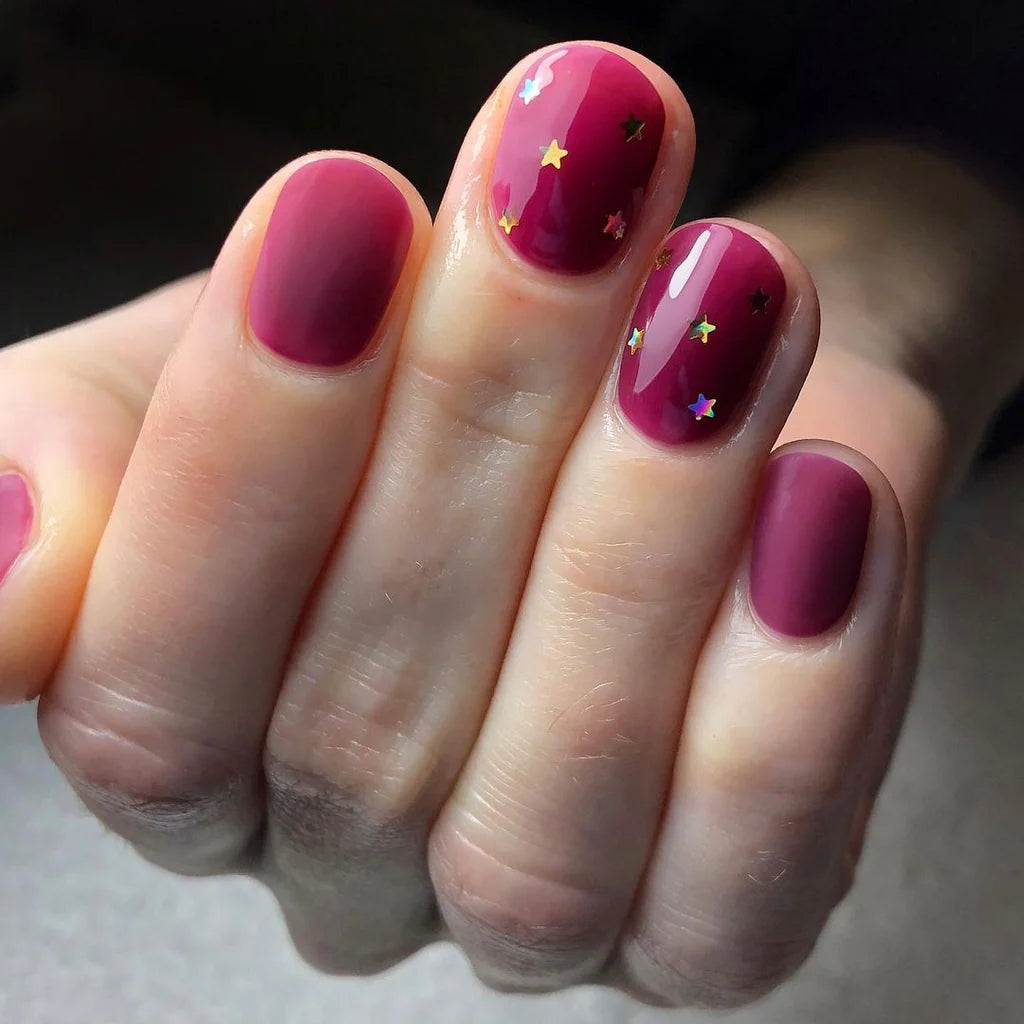 Close-up of Bio Sculpture Gemini Nail Polish No. 86 Dark Plum polish on light skin – non-toxic, deep plum shade for a refined, elegant nail look
