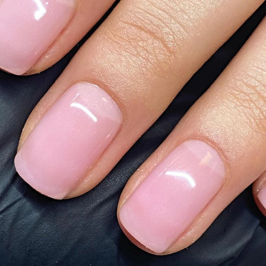 Close-up of Bio Sculpture Gemini Nail Polish No. 87 Strawberry French polish on light skin – non-toxic, delicate strawberry pink shade for a refined, everyday nail look