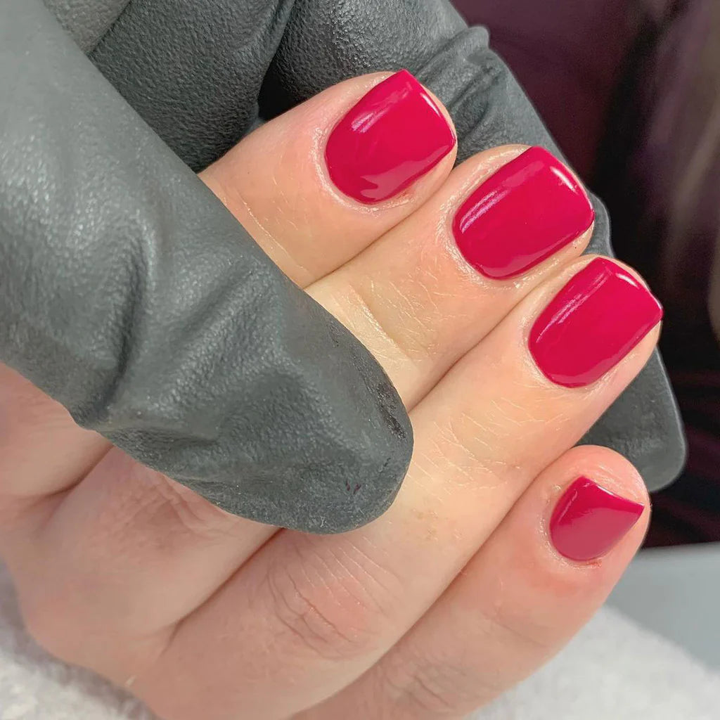 Close-up of Bio Sculpture Gemini Nail Polish No. 90 Cerise Pink polish on light skin – non-toxic, bright cerise pink shade for a lively, modern nail look