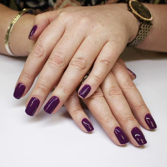 Hand wearing Bio Sculpture Gemini Nail Polish No. 92 Amethyst – vegan, medium cream purple polish for a chic, sophisticated nail look