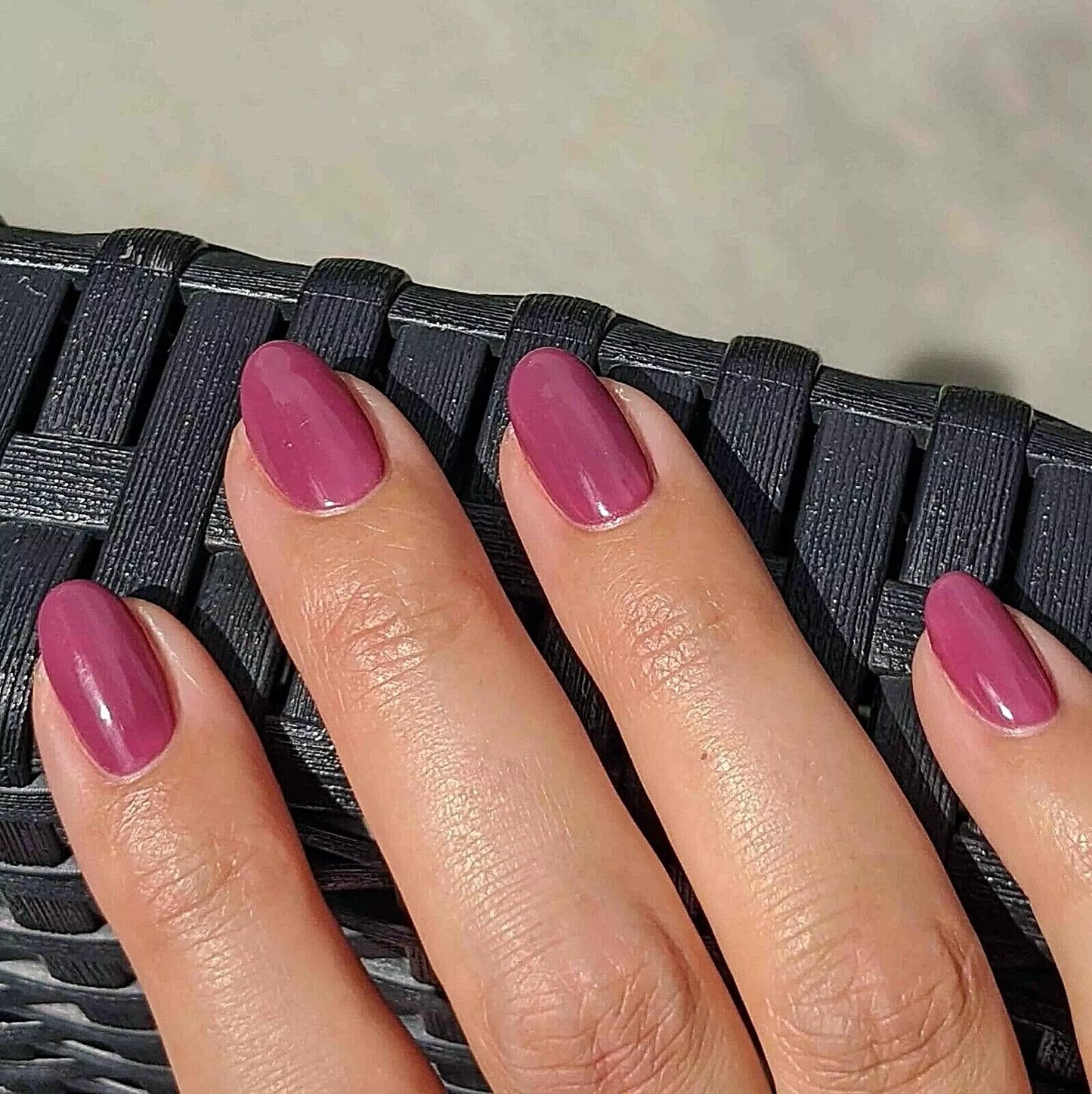 Fingers painted with Bio Sculpture Gemini Nail Polish No. 99 CCherry Liqueur on light skin – breathable, creamy cherry red polish for a polished, statement style