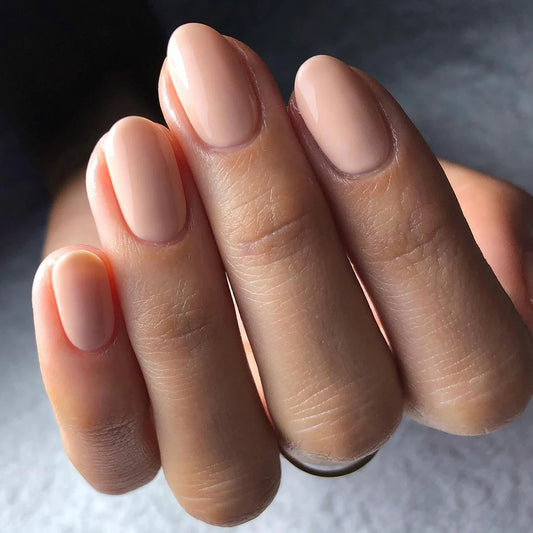 Close-up of Bio Sculpture Gemini Nail Polish No. 2003 Nude polish on light skin – non-toxic, soft nude shade for a refined, everyday nail look