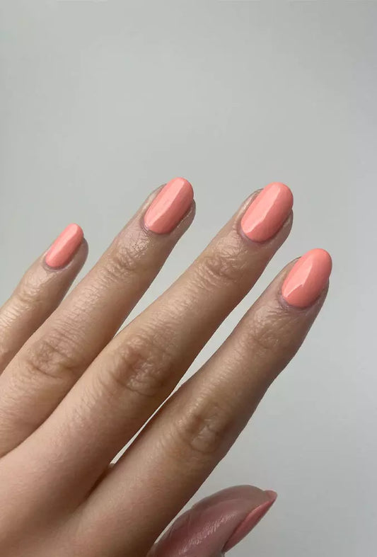 Hand wearing Nailberry Peach of My Heart nail polish – gentle, non-toxic peach shade for a natural, radiant nail look