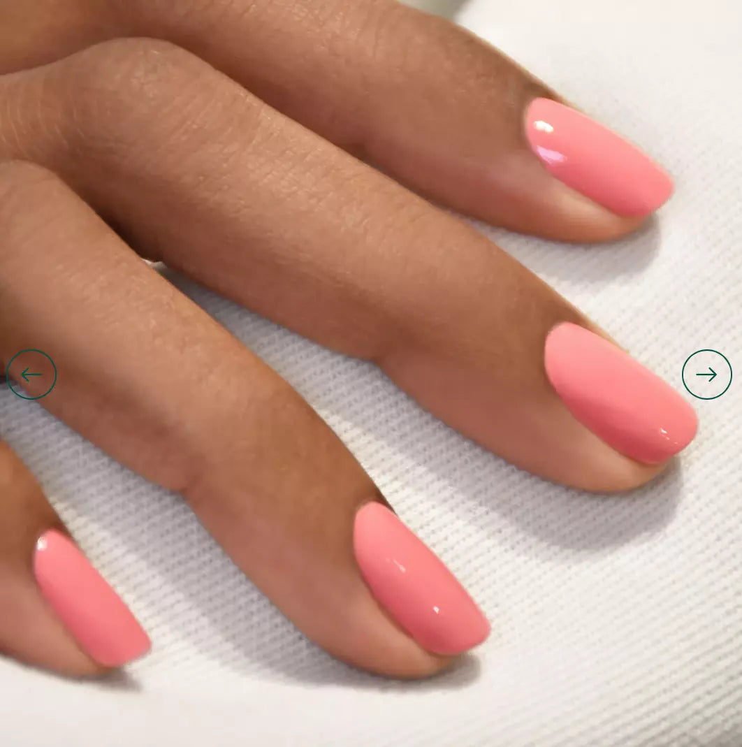 Close-up of Pink Paradise polish on darker skin – bright, eco-friendly pink shade for striking, inclusive nail looks