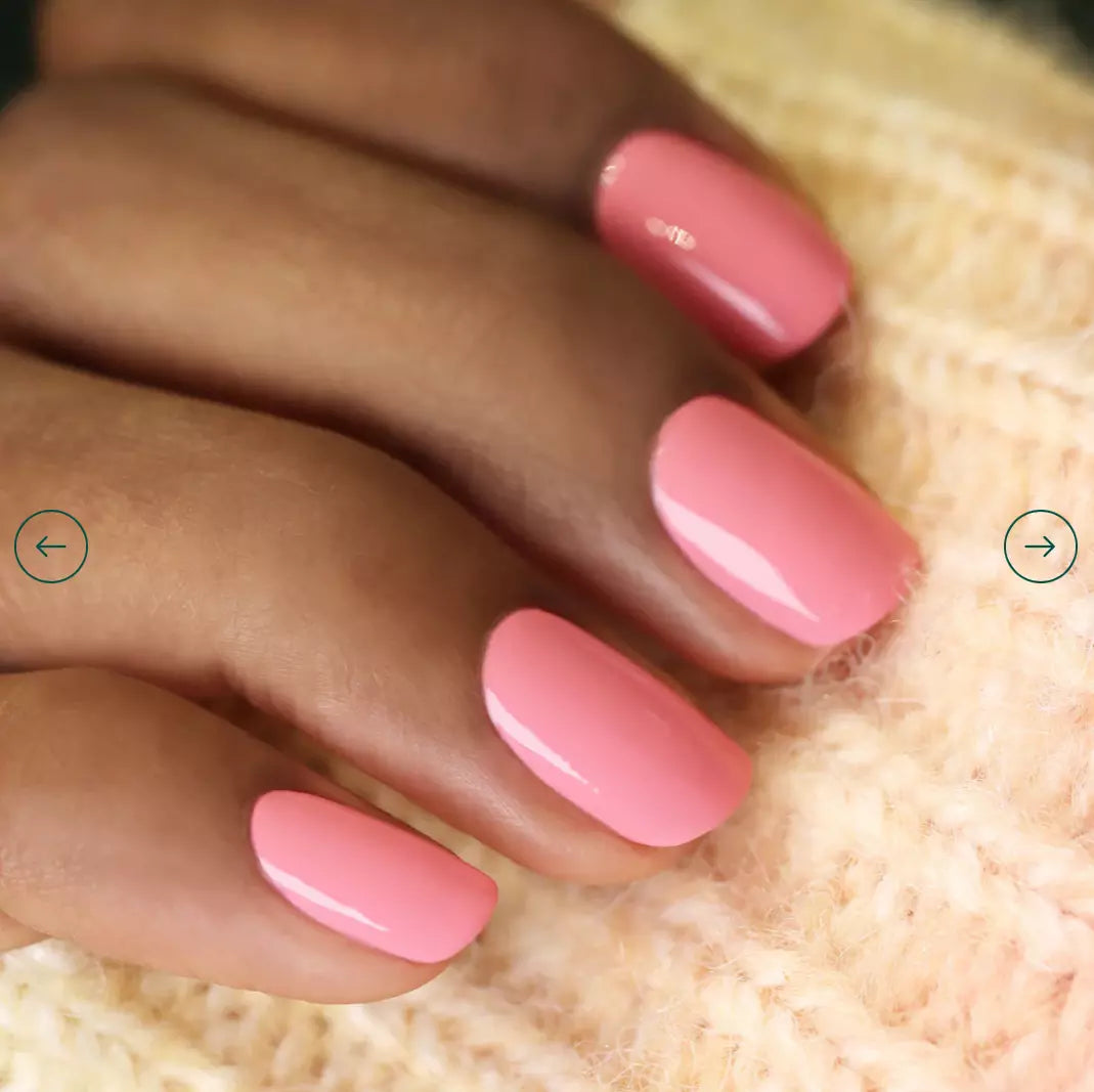 Hand with darker skin tone wearing Manucurist Pink Paradise – vivid, vegan pink polish for beautifully contrasting manicures