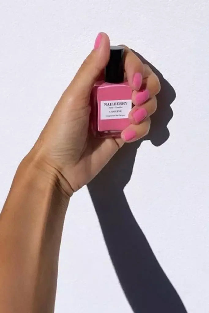 Hand with Nailberry Pink Tulip nail polish – soft, oxygenated pink shade for elegant, natural-looking manicures