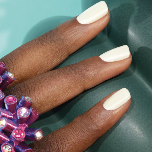 Hand with dark skin tone wearing Manucurist Porcelaine – subtle, vegan white polish for a sophisticated, inclusive manicure
