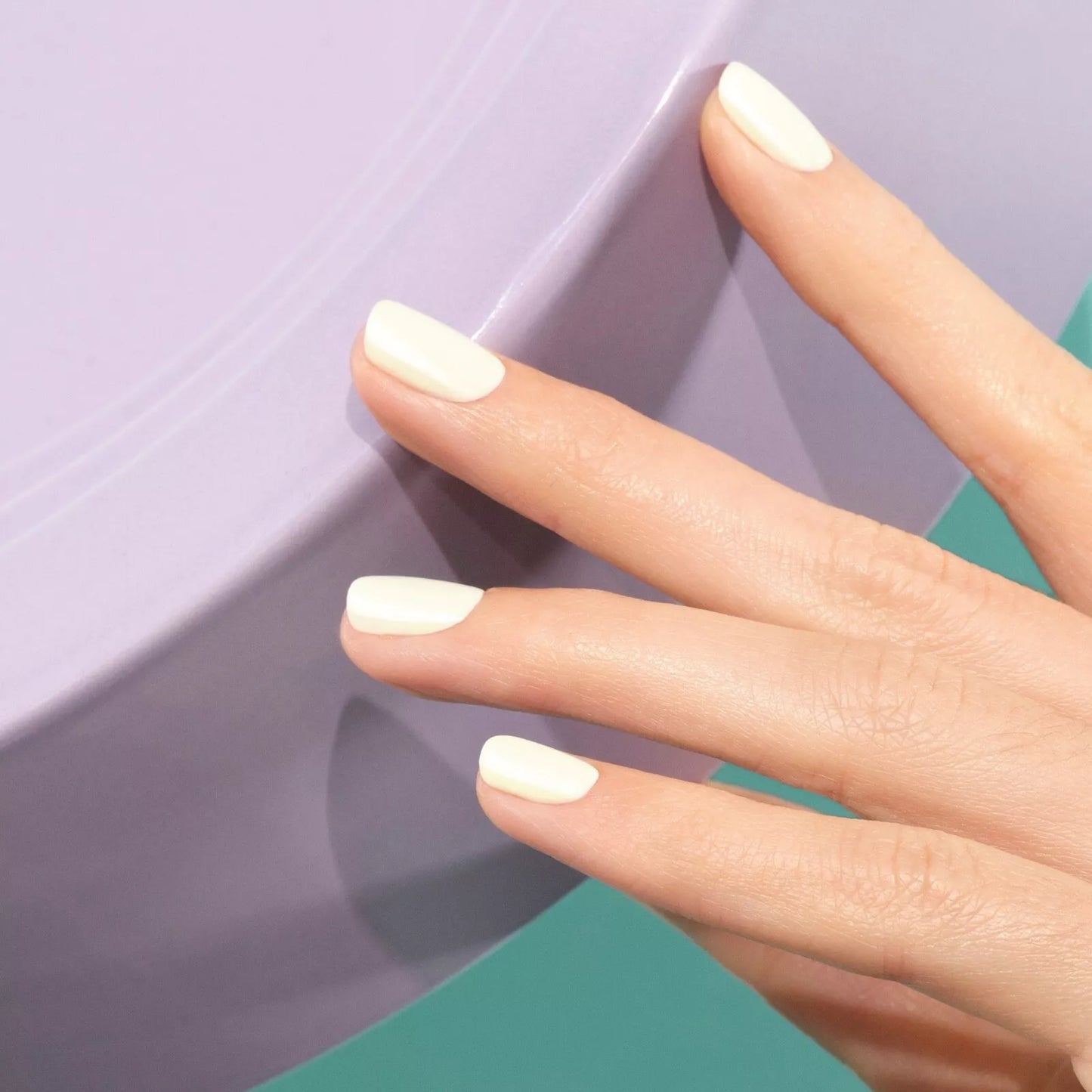 Hand with light skin tone wearing Manucurist Porcelaine – gentle, vegan white polish for a natural, refined manicure