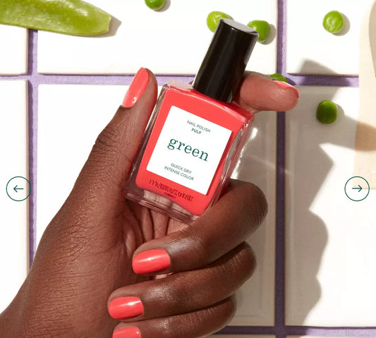 Hand with darker skin tone wearing Manucurist Pulp – lively, vegan coral polish for bold, inclusive manicures