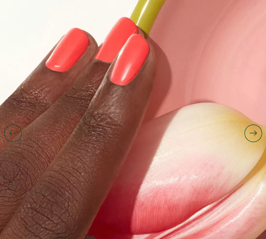 Close-up of Pulp polish on darker skin – eco-friendly, soft coral shade for a radiant nail look