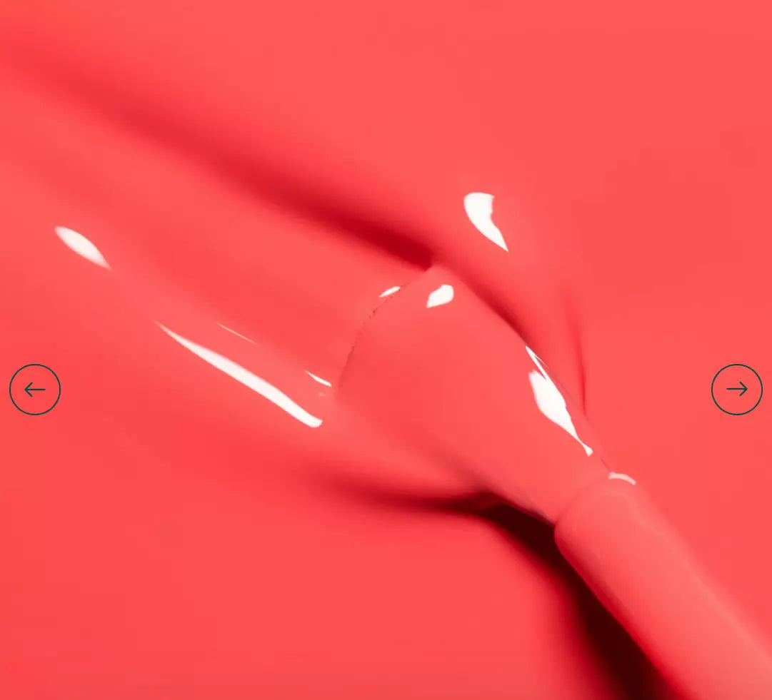 Polish brush dipped in Manucurist Pulp nail polish – creamy, non-toxic coral formula for smooth, even application