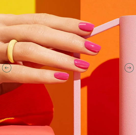 Hand with nails painted in Manucurist Paris Green Range Petula – lively, non-toxic pink polish for bold, modern nail looks