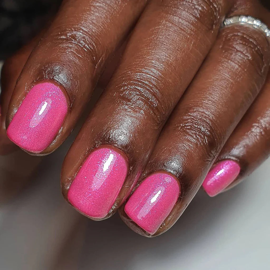 Fingers painted with Gemini Princess on dark skin – non-toxic, pastel pink polish for a chic, versatile look