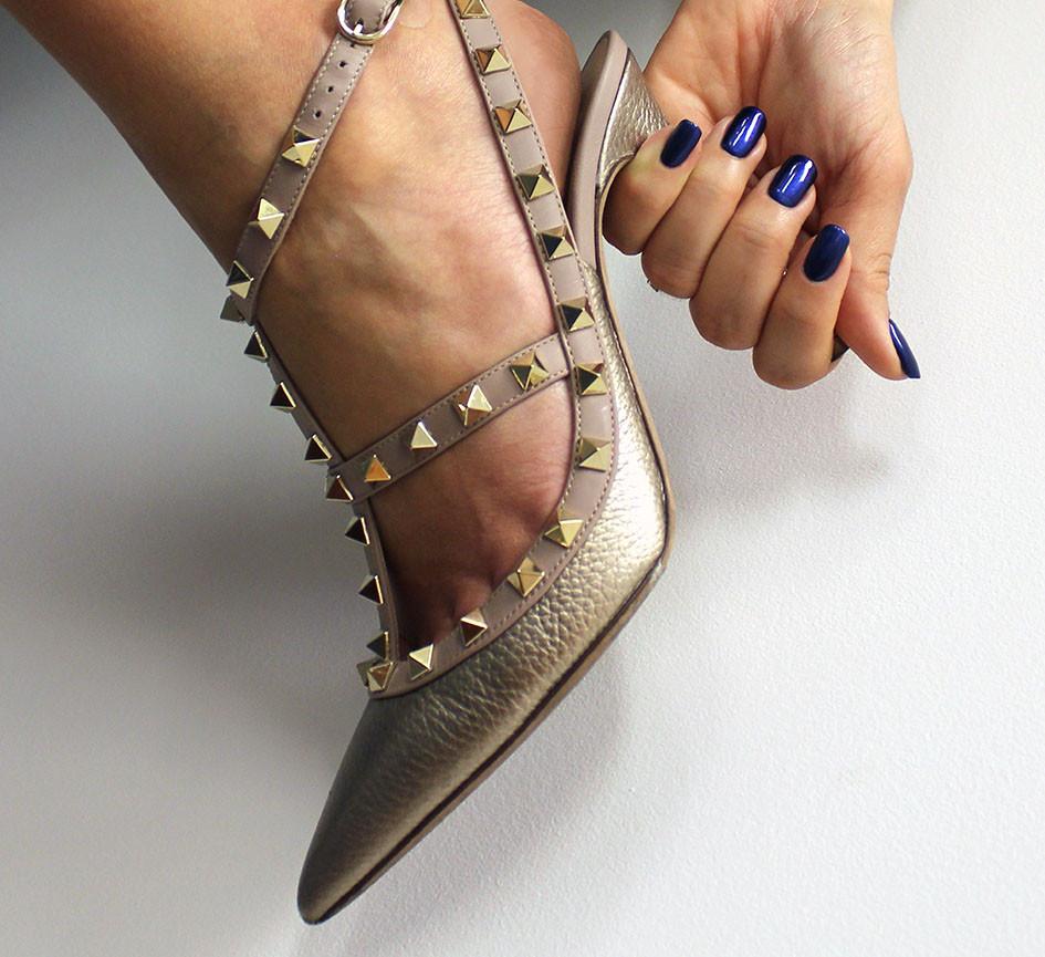 Hand wearing Bio Sculpture Gemini Nail Polish No. 264 Sapphire Song – bold, vegan deep sapphire blue polish for inclusive, striking manicures