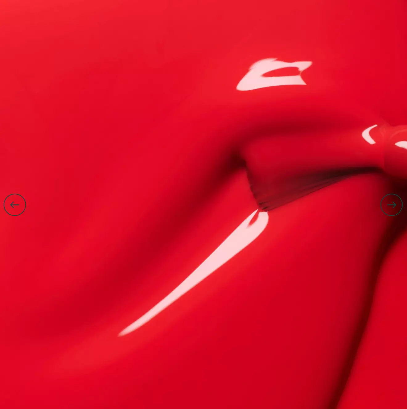 Close-up of Red Coral polish application – bright, sustainable coral red for standout manicures
