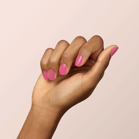 Hand with darker skin tone wearing Manucurist Rose – gentle, vegan rose pink polish for elegant, inclusive manicures