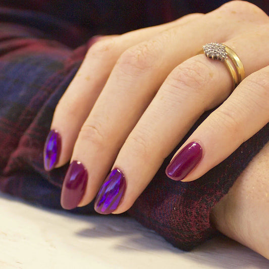 Hand wearing Bio Sculpture Gemini Nail Polish No. 61 Violet – vegan, deep violet polish for a chic, sophisticated nail look
