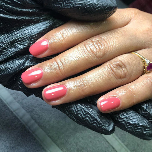 Hand with light skin tone wearing Bio Sculpture Gemini Nail Polish No. 15 Wild Berry – vegan, dusty berry pink polish for a soft, sophisticated nail look