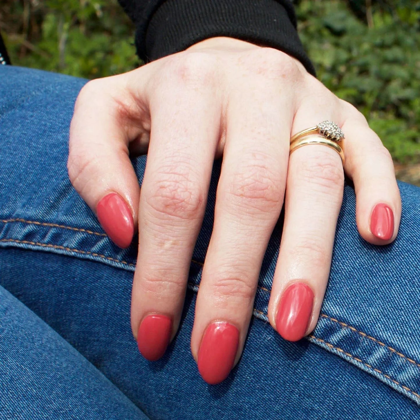 Hand with dark skin tone wearing Bio Sculpture Gemini Nail Polish No. 15 Wild Berry – bold, vegan dusty berry pink polish for inclusive, radiant manicures