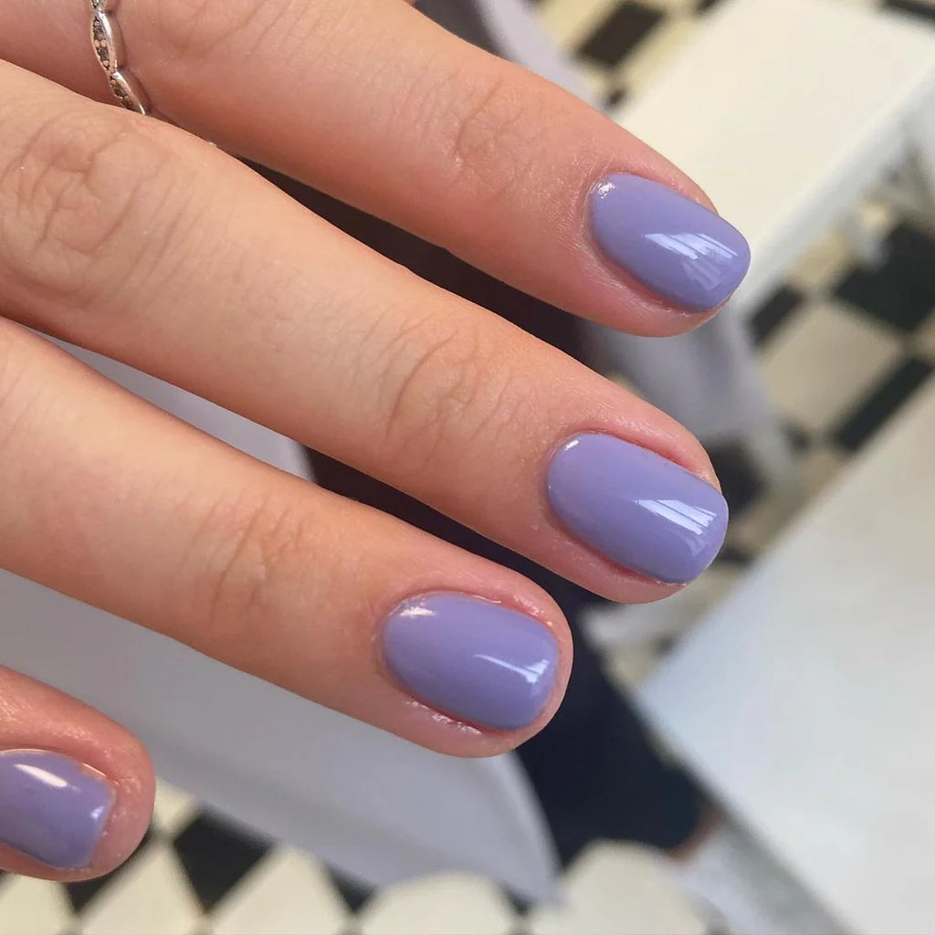 Close-up of Bio Sculpture Gemini Nail Polish No. 224 Wild Orchid polish on light skin – non-toxic, bright orchid purple shade for a striking, modern nail look
