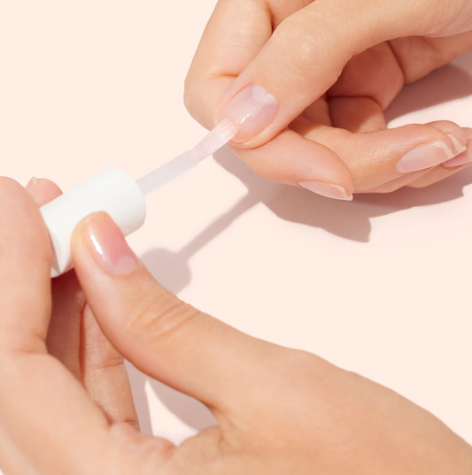 Applying Manucurist Bitter Polish – brush-on vegan anti-biting nail treatment for natural nail protection