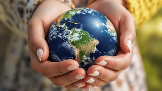 Close-up of a woman's hands gently holding a miniature Earth, symbolising care for the planet and eco-friendly practices
