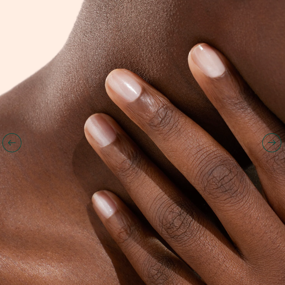 Hand with darker skin tone wearing Manucurist Active Shine – transparent, eco-friendly base coat for a healthy, radiant nail look