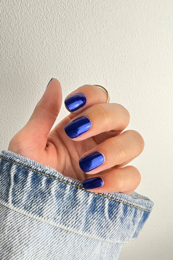 Hand wearing Nailberry Blue Moon nail polish – gentle, non-toxic pastel blue shade for stylish, healthy nails
