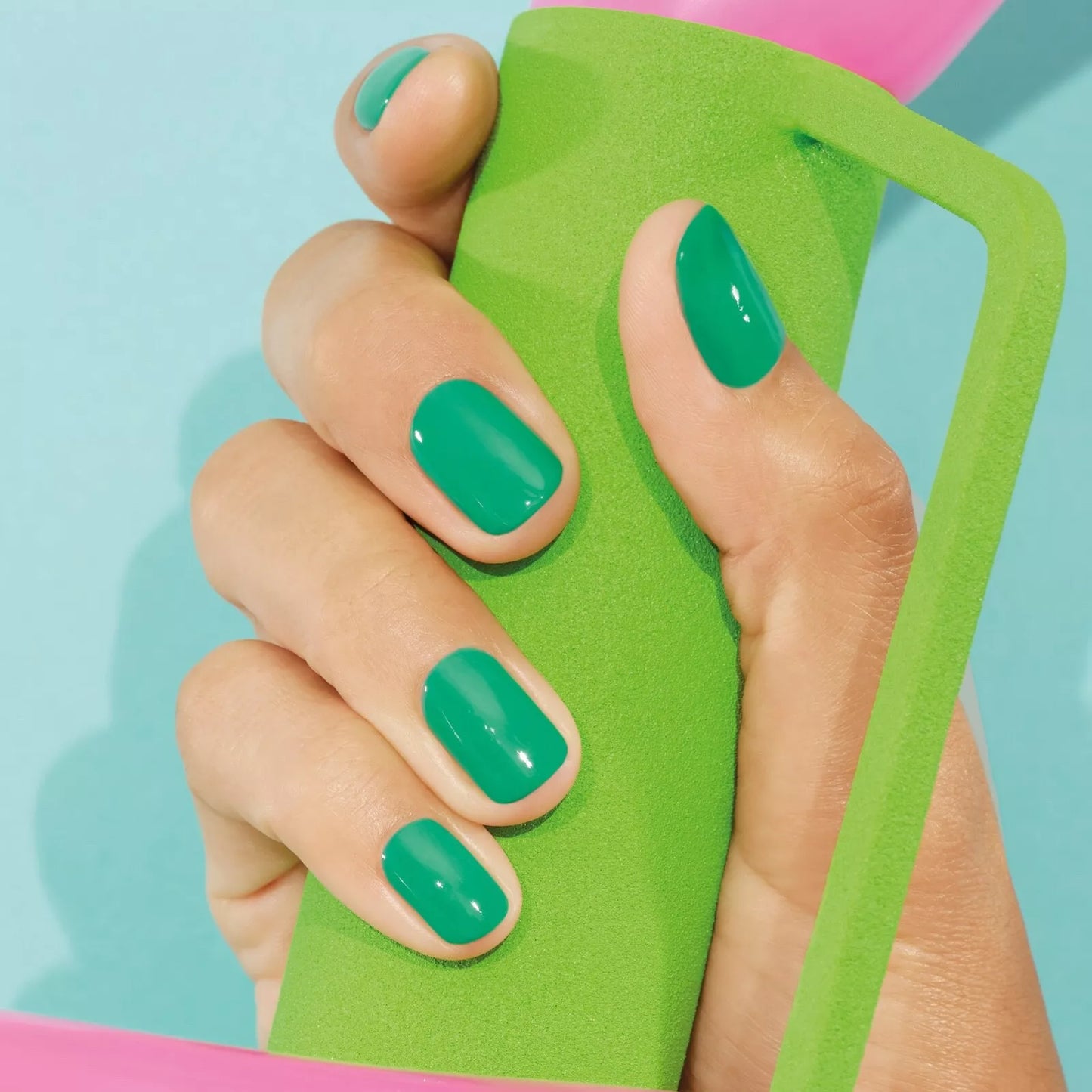 Hand with light skin tone wearing Manucurist Brazil – vibrant, vegan yellow polish for lively, modern manicures
