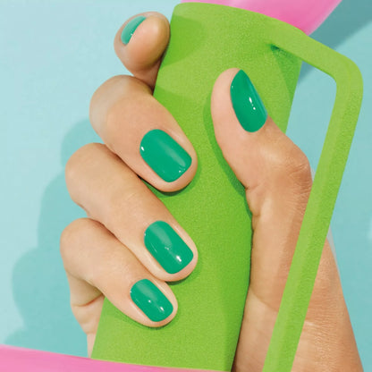 Hand with light skin tone wearing Manucurist Brazil – vibrant, vegan yellow polish for lively, modern manicures