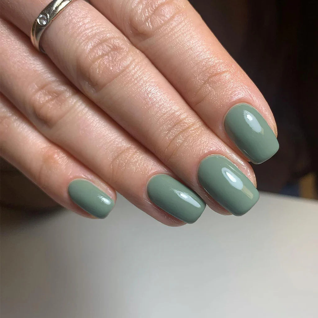 Hand with light skin tone wearing Bio Sculpture Gemini Nail Polish No. 225  Hazy Forest – vegan, Lydia Millin Evergreen polish for a chic, elegant nail look