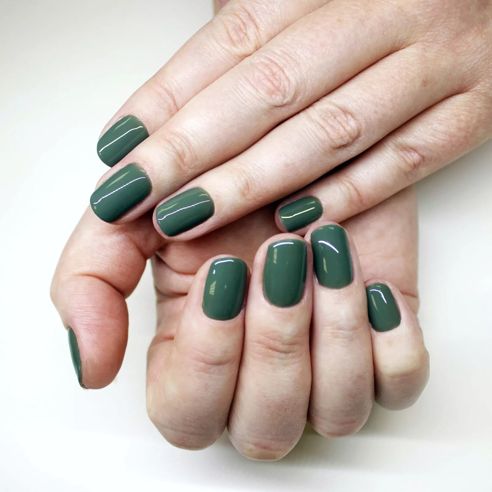 Hand wearing Bio Sculpture Gemini Nail Polish No. 225  Hazy Forest – vegan, evergreen-inspired polish for a versatile, modern manicure