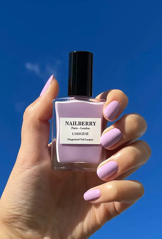 Hand holding Nailberry Lavender Fields nail polish – soft lavender vegan polish for elegant, natural-looking manicures