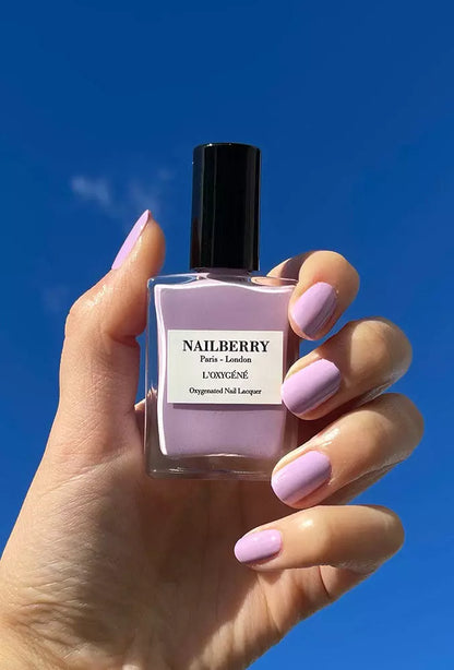 Hand holding Nailberry Lavender Fields nail polish – soft lavender vegan polish for elegant, natural-looking manicures