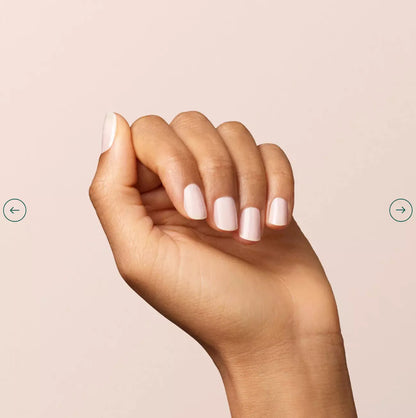 Fingers painted with Manucurist Milky White on darker skin – non-toxic, subtle white polish for modern style